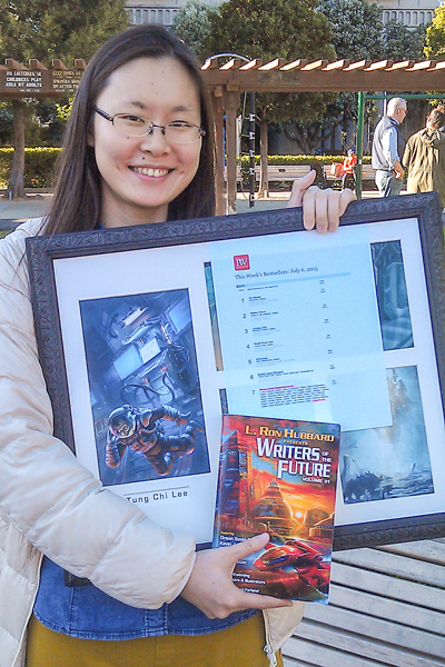 Jessica with her illustration for Writers of the Future Vol 31 and bestseller list