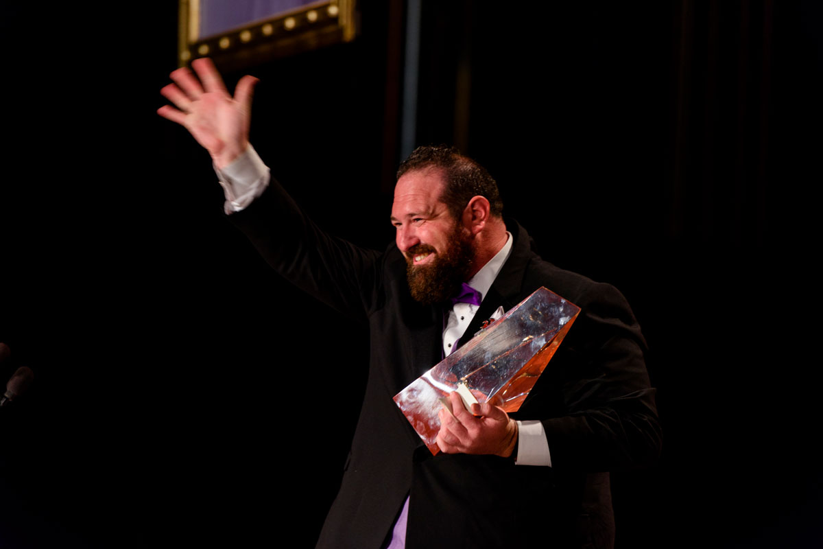 Jake Marley on stage with the Golden Pen Award