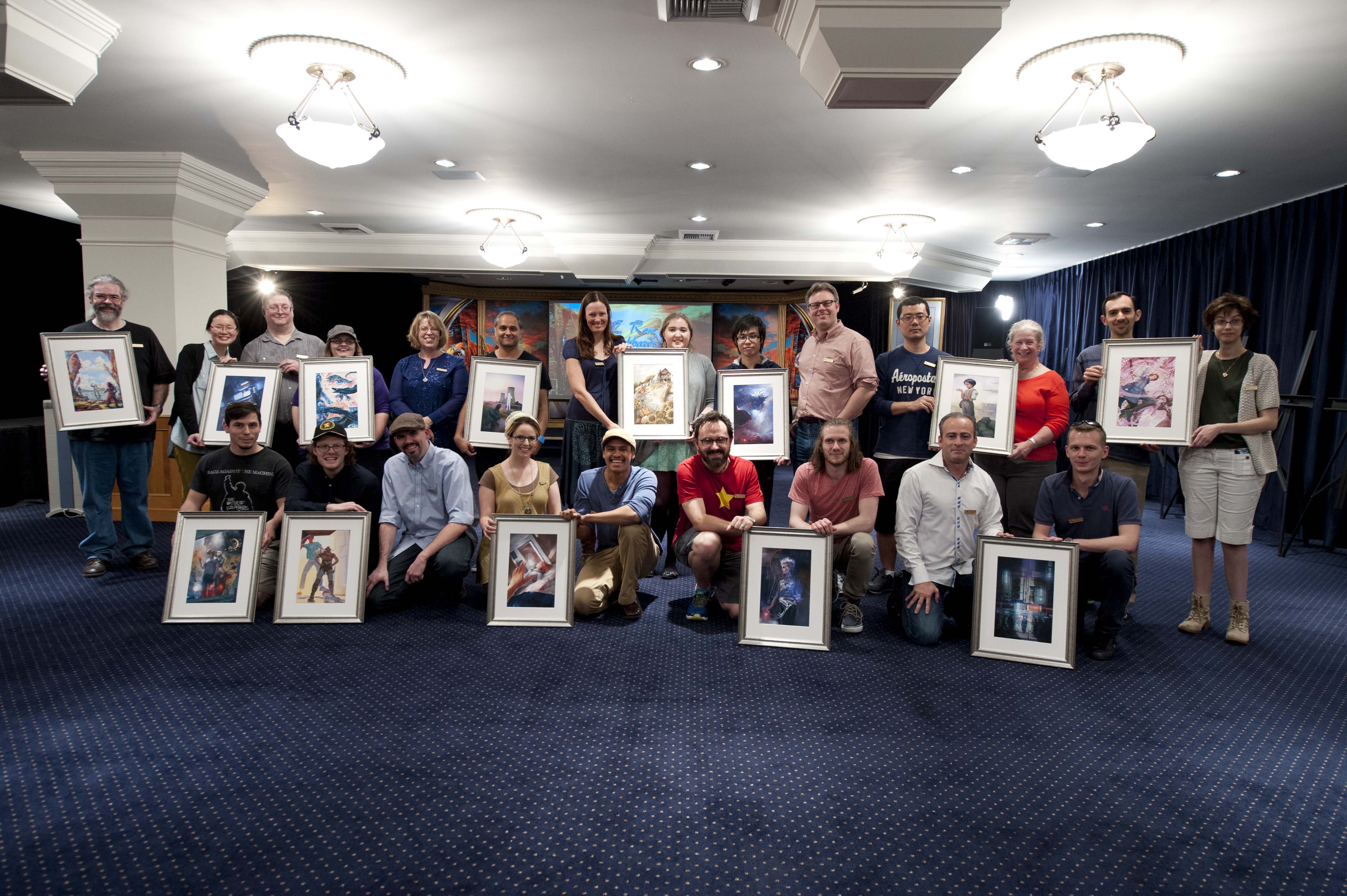 Group shot of the artists with their illustration and the authors to the stories.