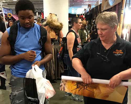 Kathy Lackey handing out posters