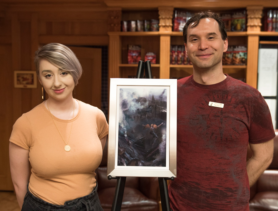 Artist Alana Fletcher with Eneasz and the artwork for his story